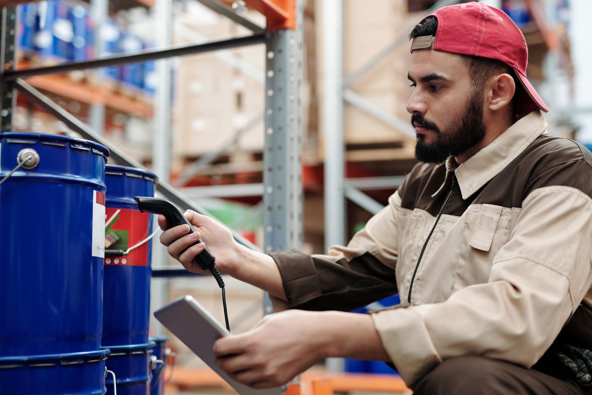 Worker scanning a barcode label in a warehouse aisle