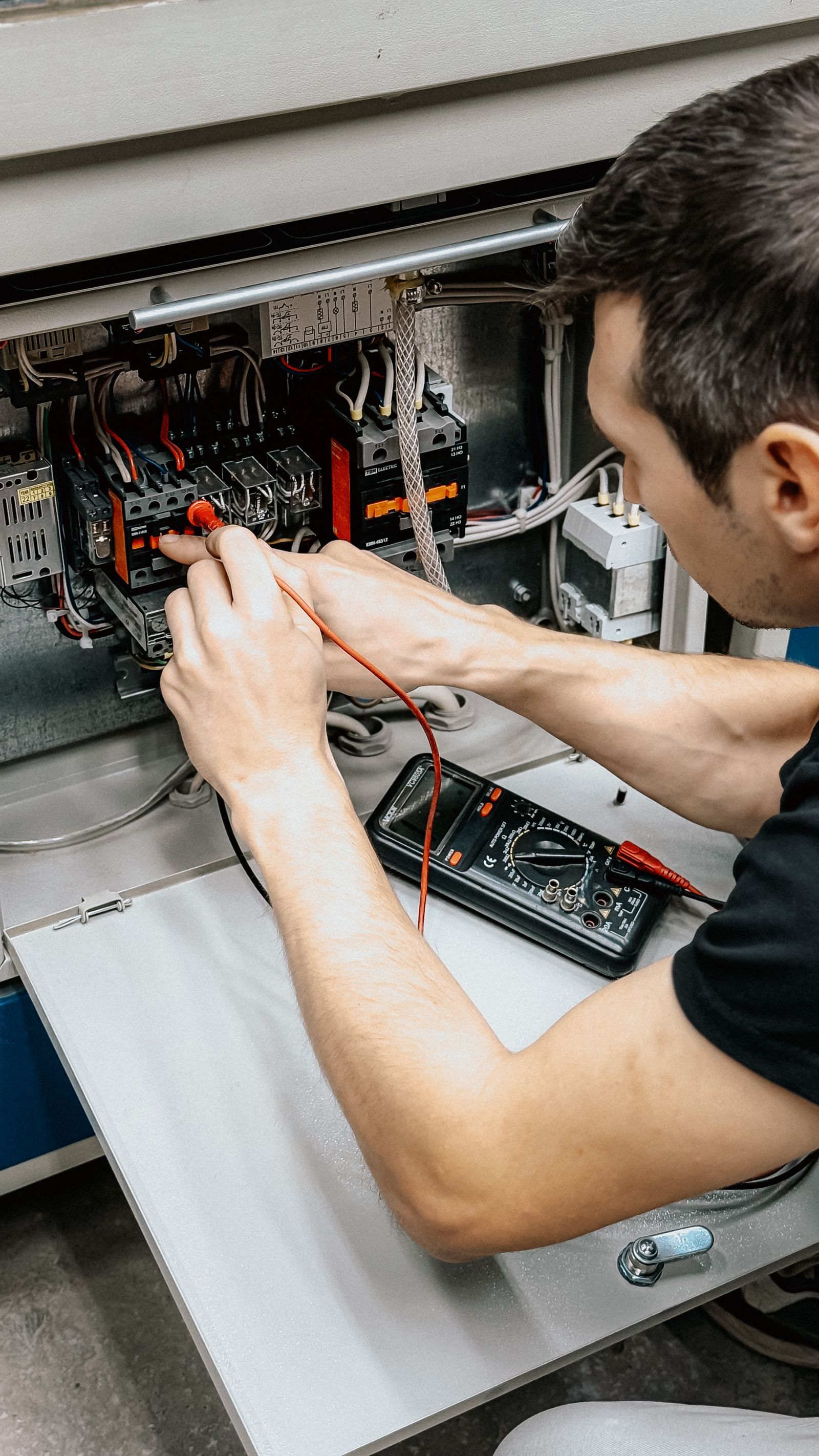 Electrician wiring a distribution panel