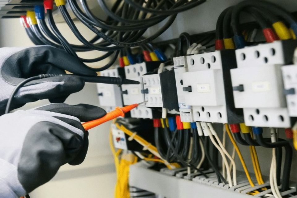 Electrician testing an electrical panel