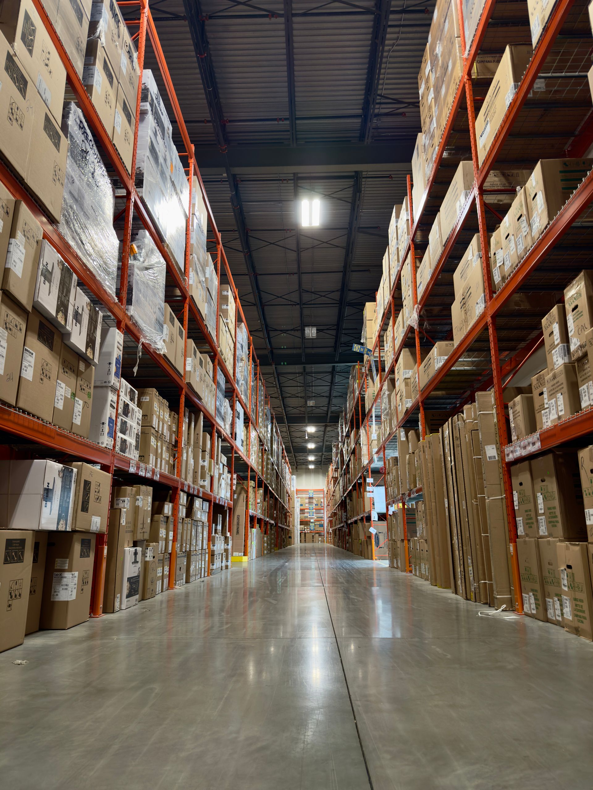 Warehouse aisle with tall stocked racks
