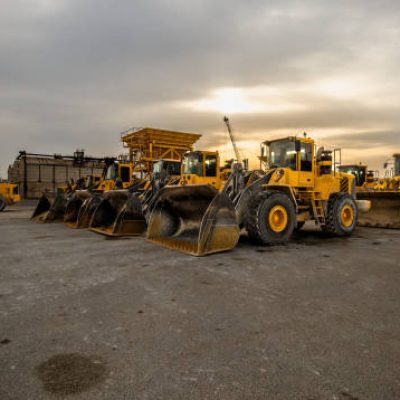 istockphoto-2171996899-612×612 yellow wheel loader or bulldozer in formation. Earthmoving and aggregates. Construction work.
