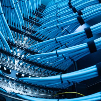 istockphoto-2204472107-612×612 A close-up image of organized blue network cables in a server rack, showcasing efficient data transmission and connectivity in a modern technology setup.